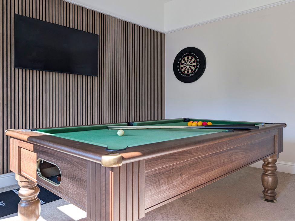 A game room with a pool table and dartboard at Rosemount Boutique in Windermere