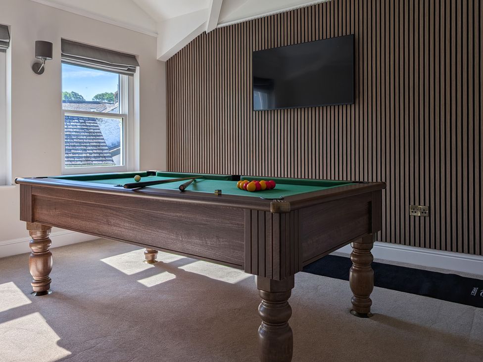 A game room with a pool table and television at Rosemount Boutique in Windermere