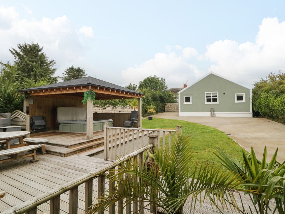 A garden with a gazebo and green house at Woodside Guest House Castlerock