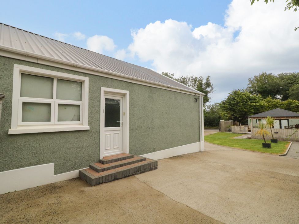 An exterior view of a house with a door and steps at Woodside Guest House in Castlerock