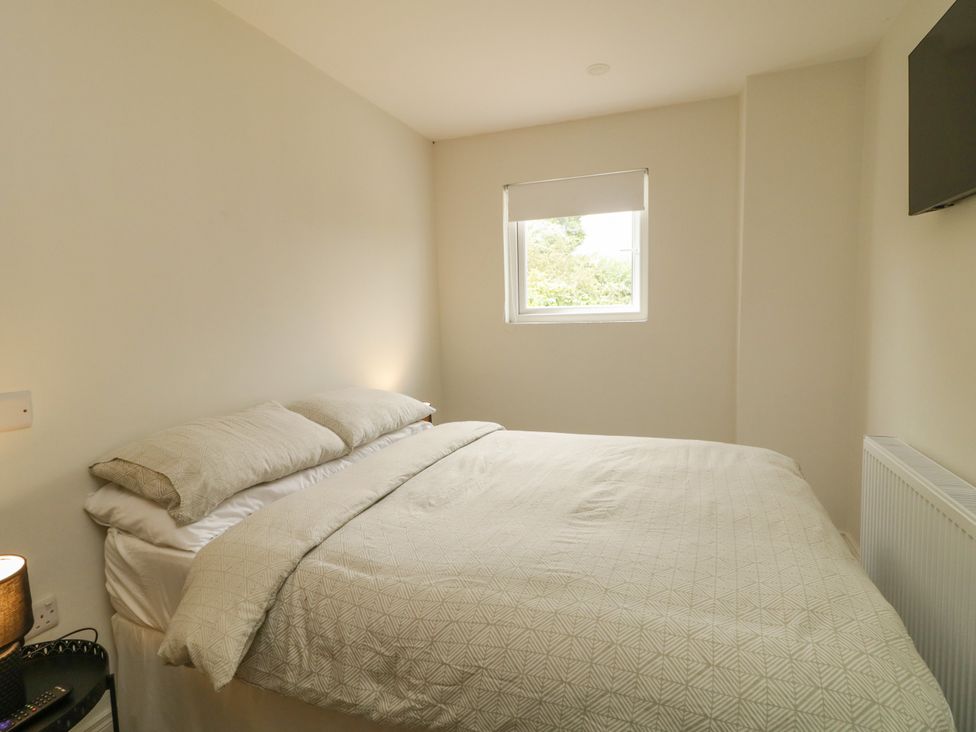 A bedroom with a bed and window at Woodside Guest House Castlerock