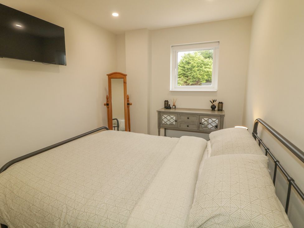 A bedroom with a bed and television at Woodside Guest House Castlerock