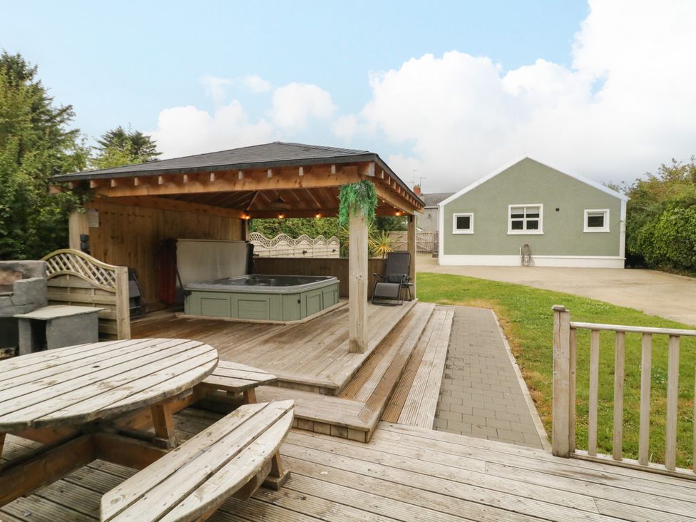 A garden with a hot tub and seating area at Woodside Guest House in Castlerock