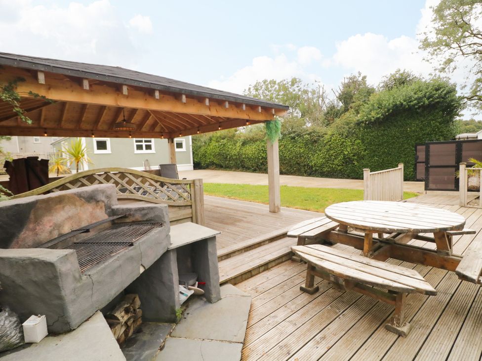 A garden with a barbecue and seating area at Woodside Guest House in Castlerock