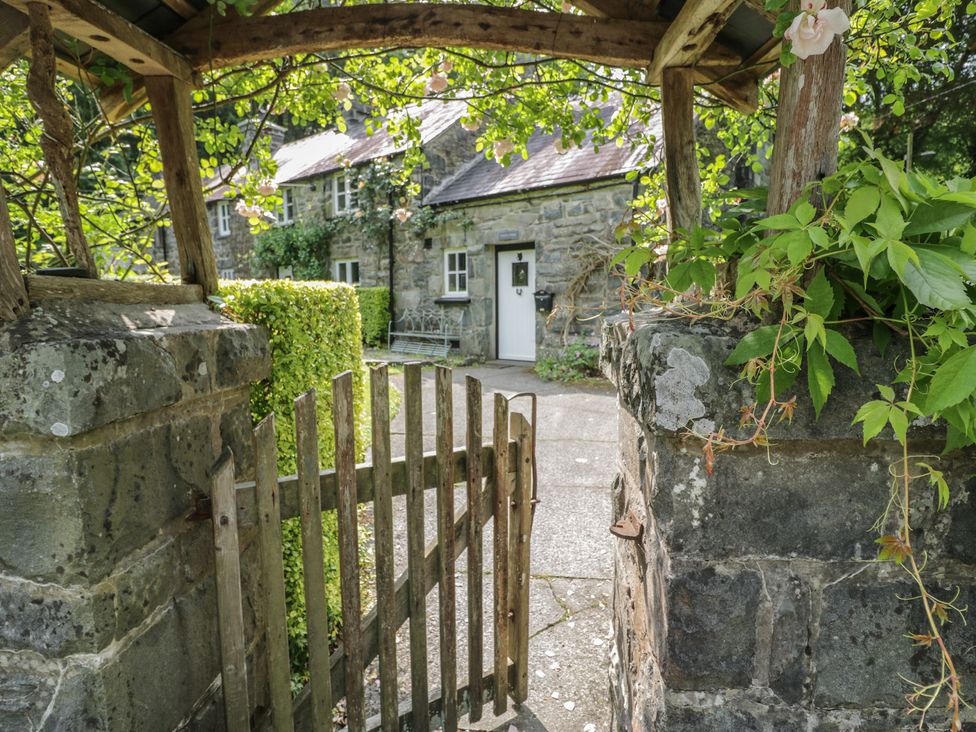 A path leading to a cottage with a wooden gate at Glandwr Cottage Llanbedr