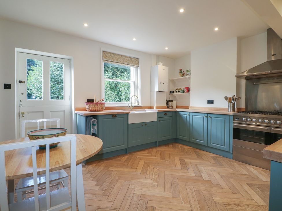 A kitchen with a sink and oven at Rectory Cottage in Chawton near Alton, Hampshire