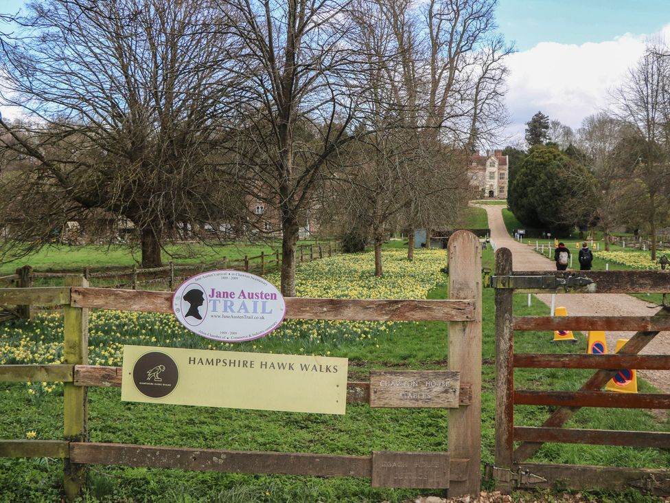 A pathway with flowers and trees at Rectory Cottage in Chawton near Alton, Hampshire