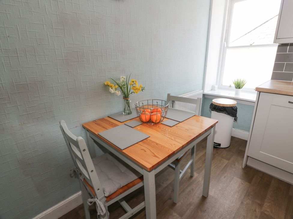 A dining room with a table set for two at Fleet Townhouse in Castle Douglas