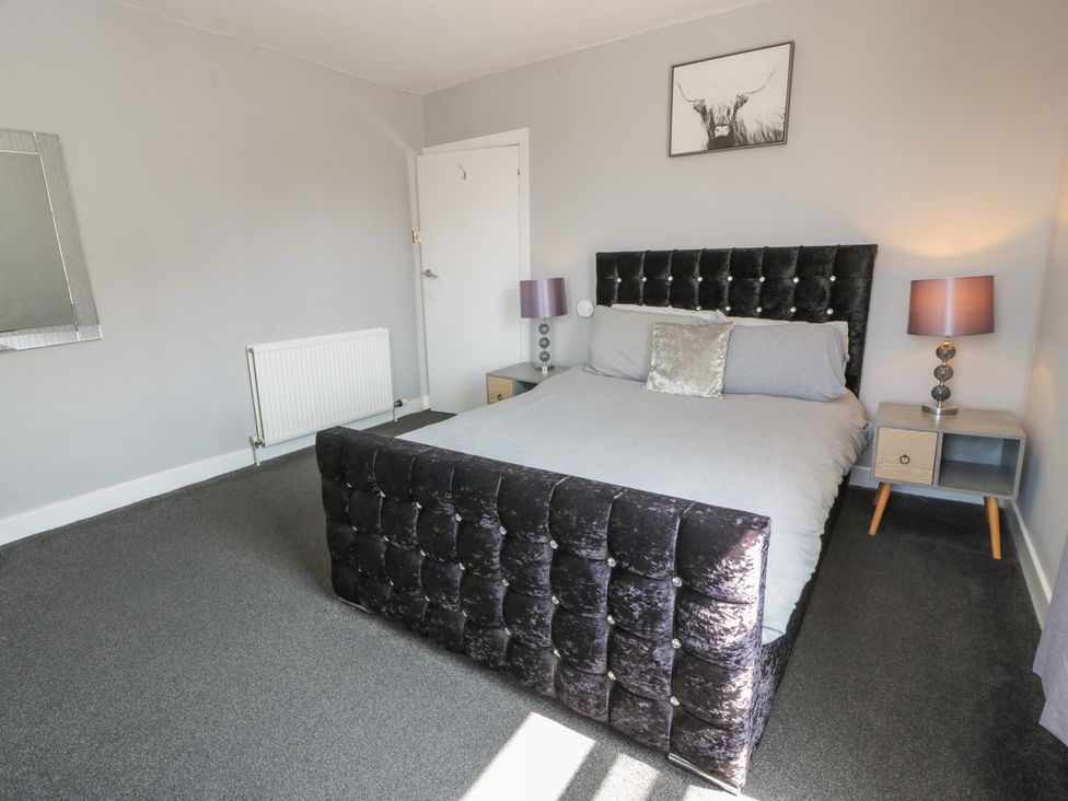 A bedroom with a bed and bedside tables at Fleet Townhouse in Castle Douglas