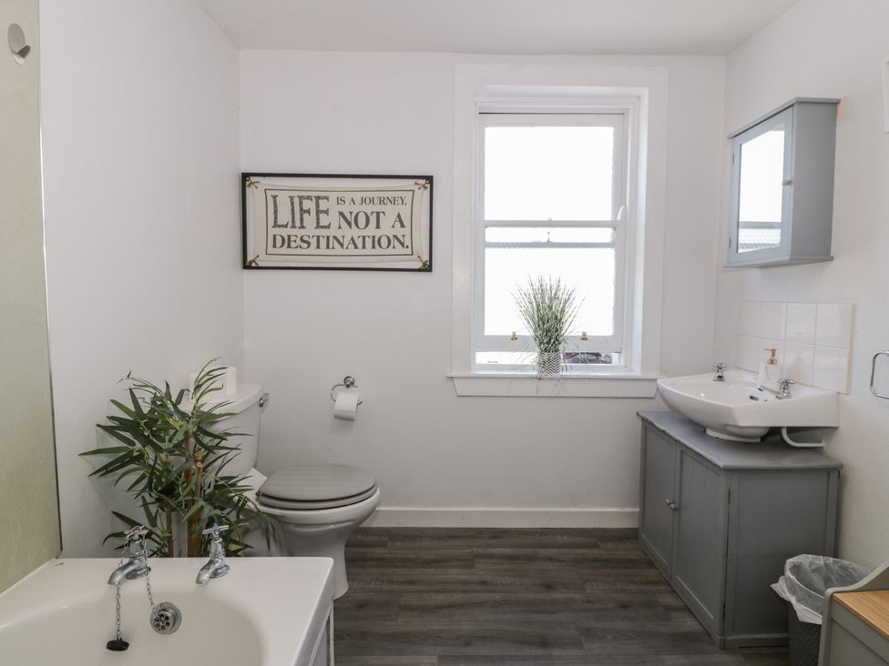 A bathroom with a sink, toilet, and tub at Fleet Townhouse in Castle Douglas