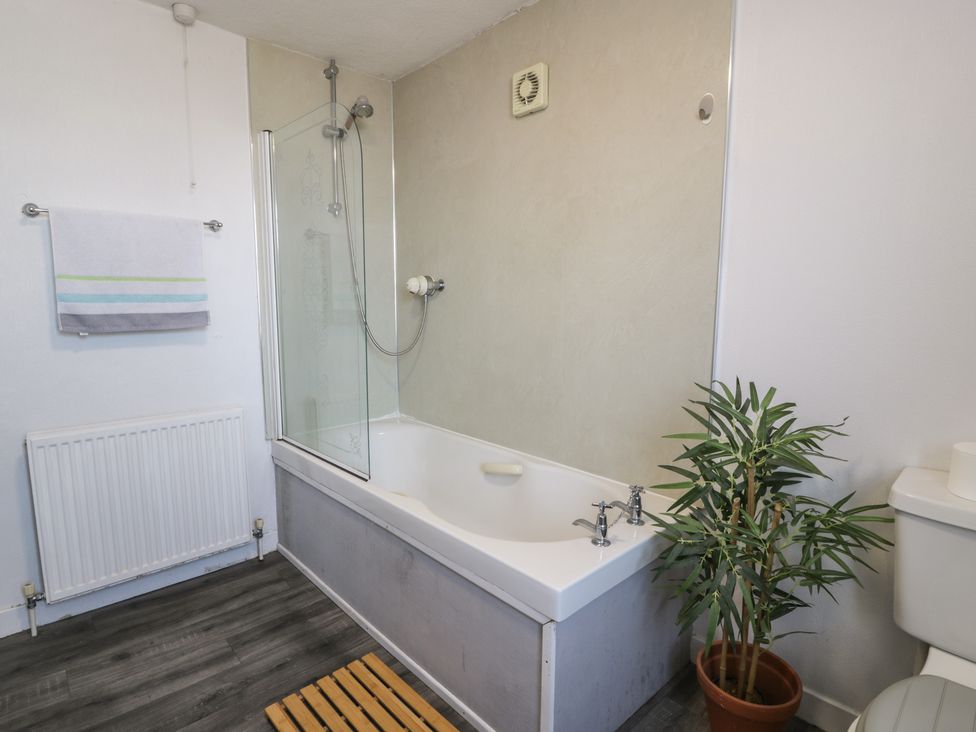 A bathroom with a bathtub and shower at Fleet Townhouse in Castle Douglas
