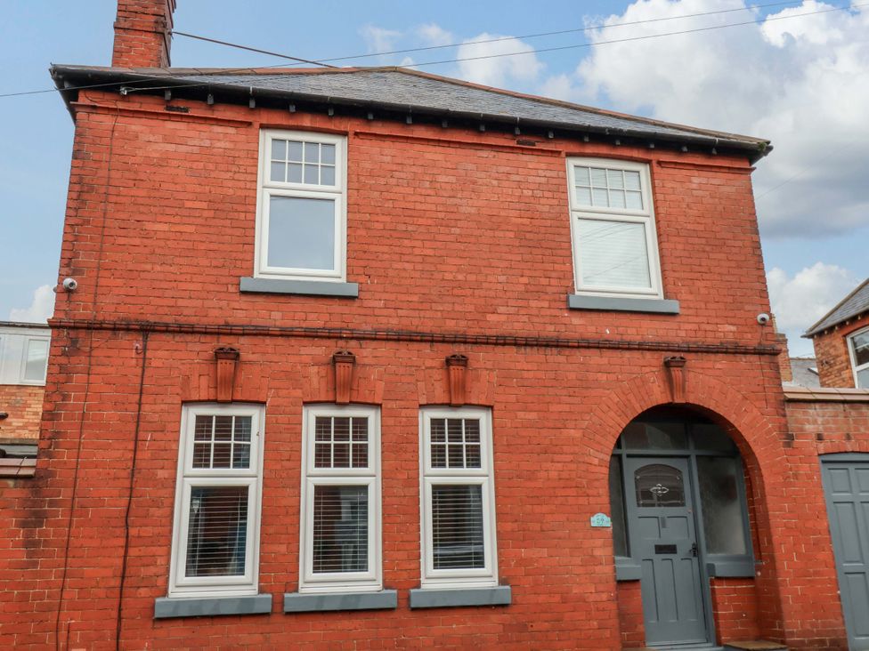 A brick exterior of a building with windows and a front door at 59 Moorland Road in Scarborough
