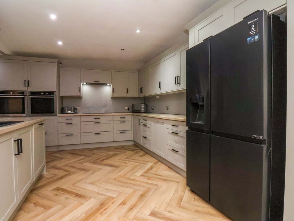 A kitchen with cabinets and appliances at 59 Moorland Road in Scarborough