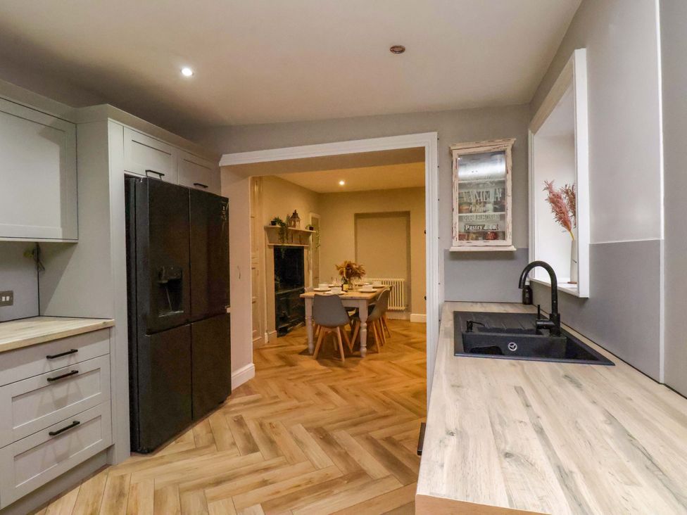 A kitchen with a refrigerator and sink at 59 Moorland Road Scarborough