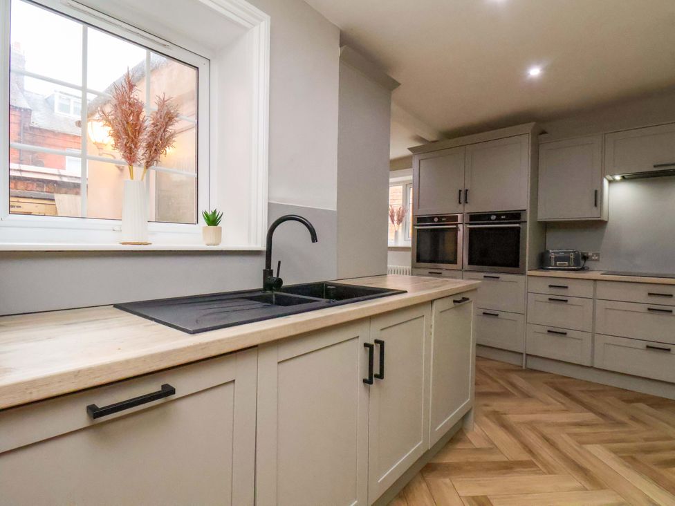 A kitchen with a sink and cabinets at 59 Moorland Road in Scarborough