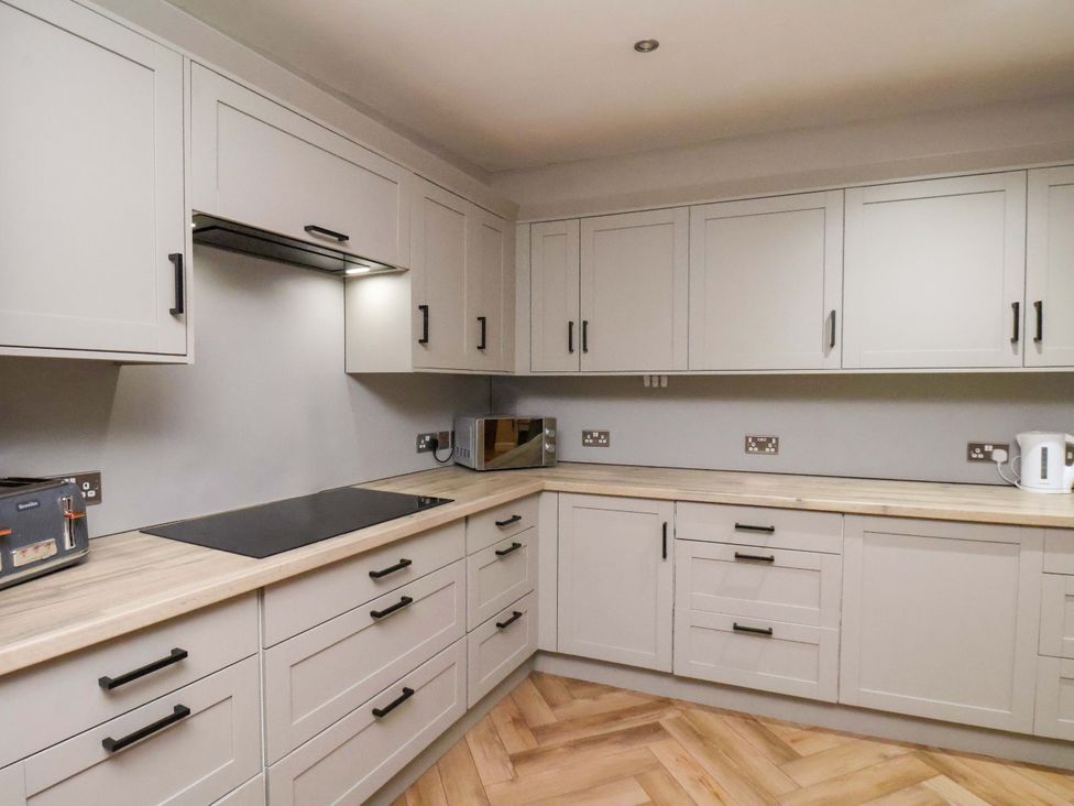 A kitchen with cabinets and appliances at 59 Moorland Road Scarborough