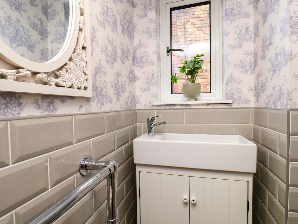 A bathroom with a sink and mirror at 59 Moorland Road Scarborough