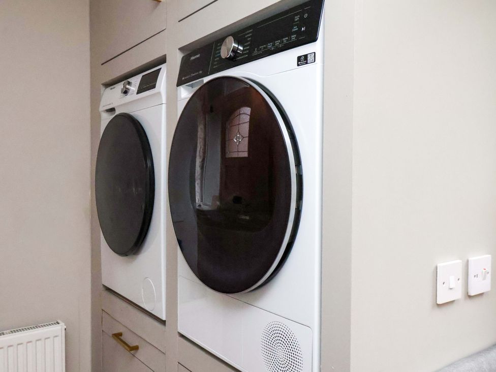 A laundry room with a washing machine and dryer at 59 Moorland Road Scarborough