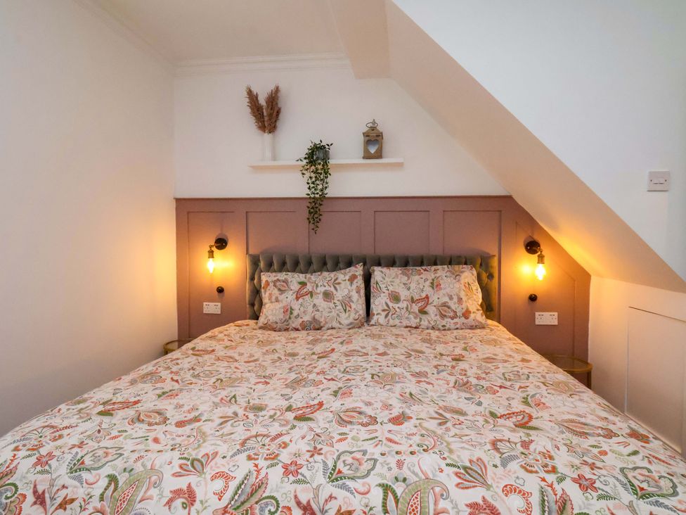 A bedroom with a bed and wall decorations at 59 Moorland Road, Scarborough