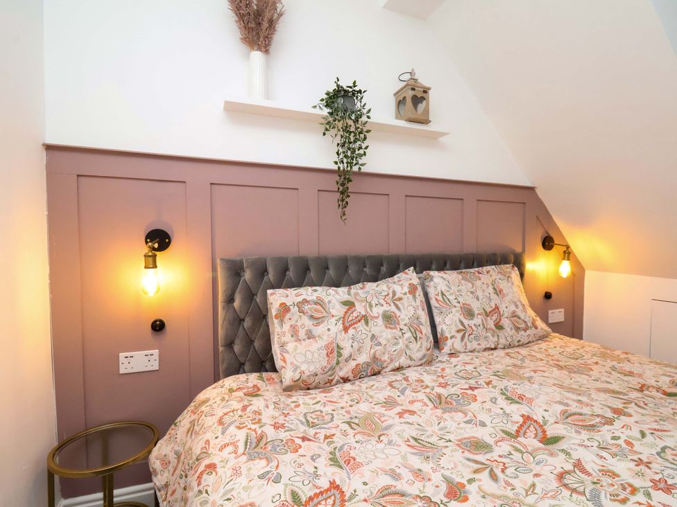 A bedroom with a bed and decorative elements at 59 Moorland Road Scarborough