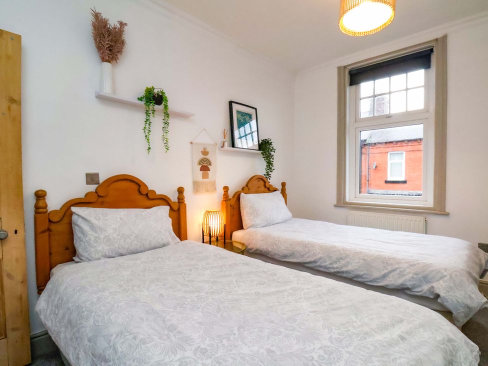 A bedroom with two beds and a window at 59 Moorland Road Scarborough