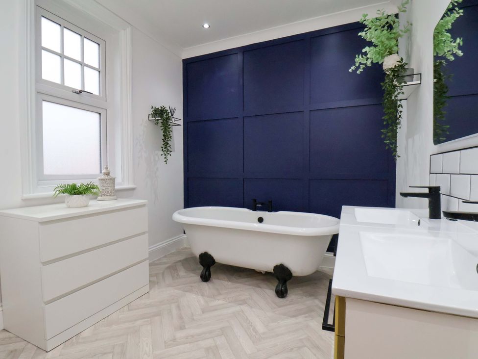 A bathroom with a bathtub and sink at 59 Moorland Road Scarborough