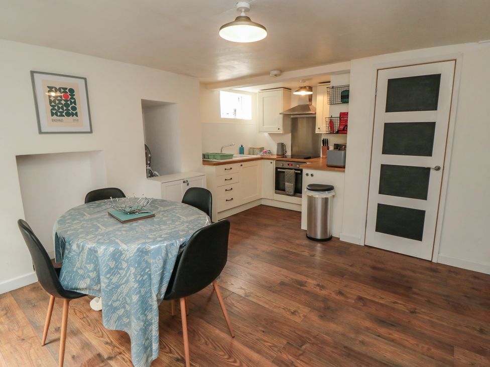 A kitchen with a table and chairs at 1 Albion Place Whitby