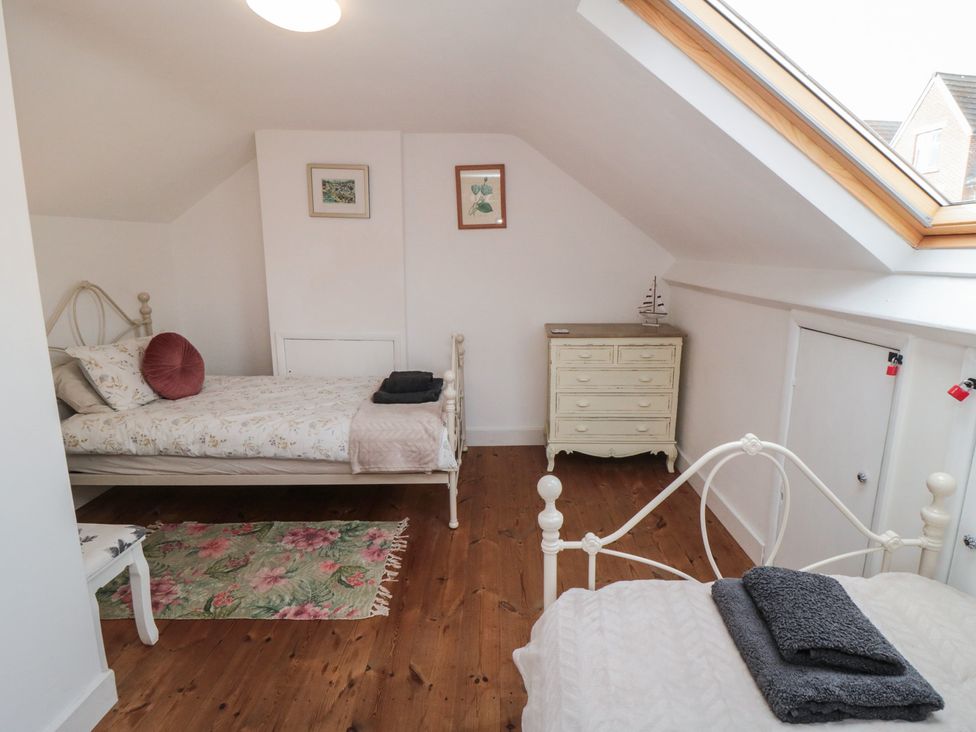 A bedroom with two beds and a dresser at 1 Albion Place in Whitby