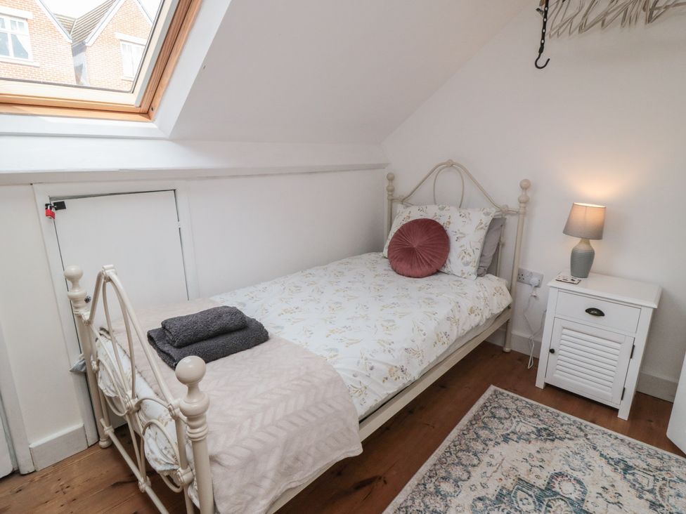 A bedroom with a bed and nightstand at 1 Albion Place in Whitby