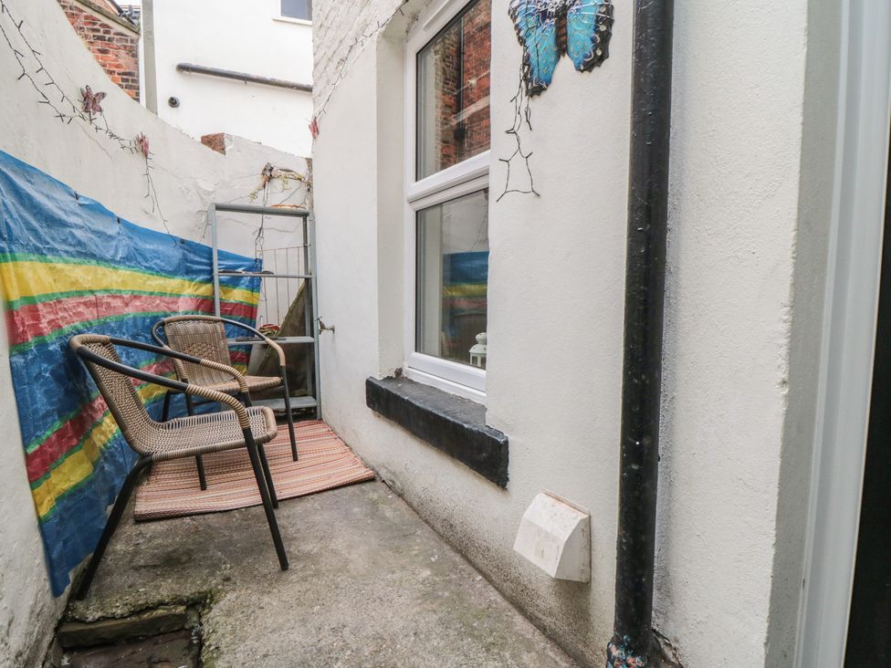An outdoor area with a chair and ladder at 1 Albion Place, Whitby