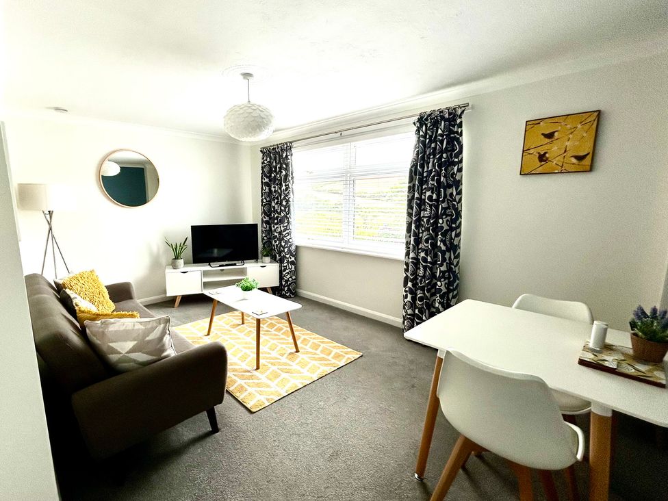 A living room with a sofa and television at 1 Chatsworth Riverscape Apartments in Newquay