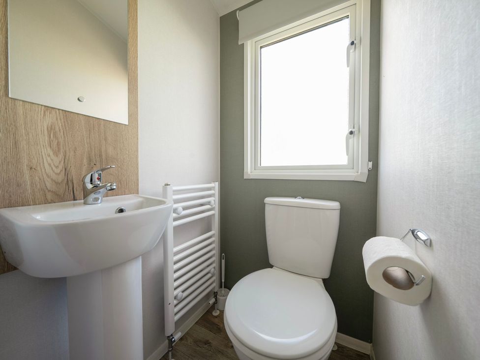 A bathroom with a toilet and wash basin at Billy’s Way - Hayling Island