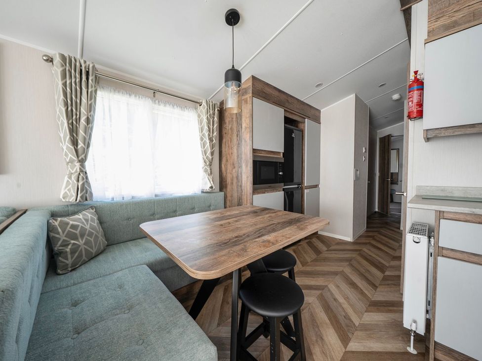 A dining area with a table and seating at Blue Flag Shores - Hayling Island