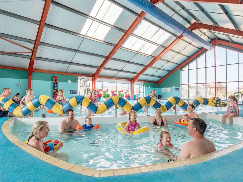 A swimming pool with families enjoying water activities at Blue Flag Shores - Hayling Island
