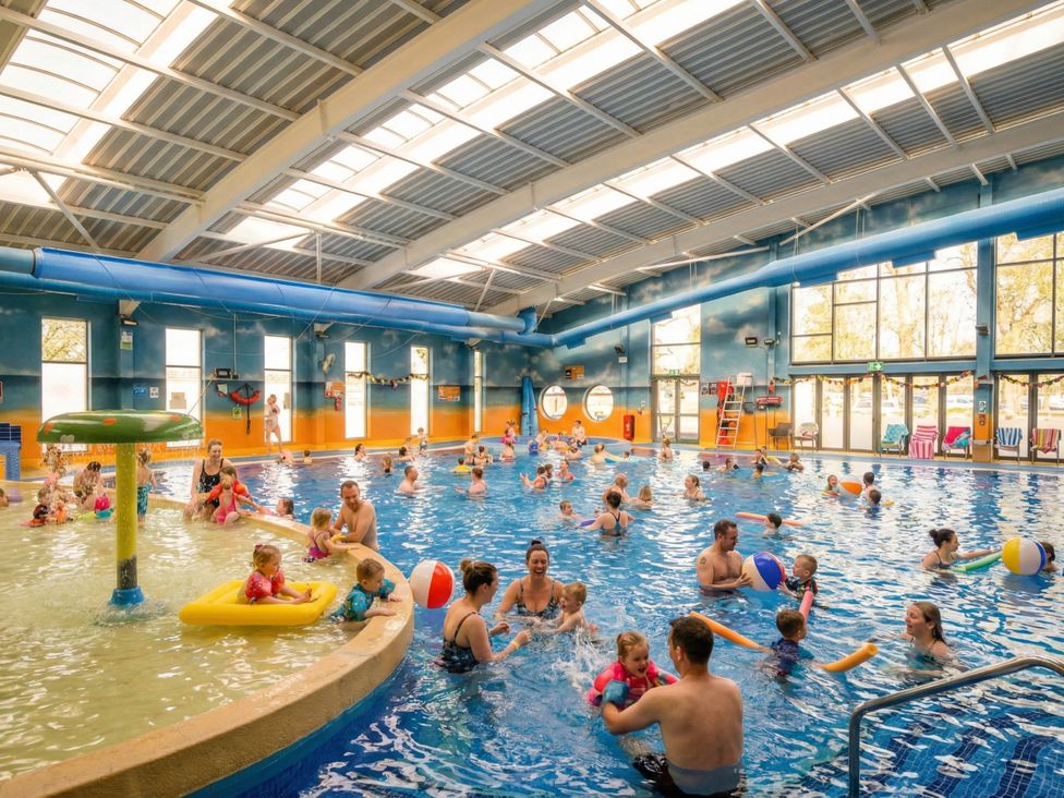 A swimming pool with children and adults playing at Ripples & Reeds - Billing Aquadrome
