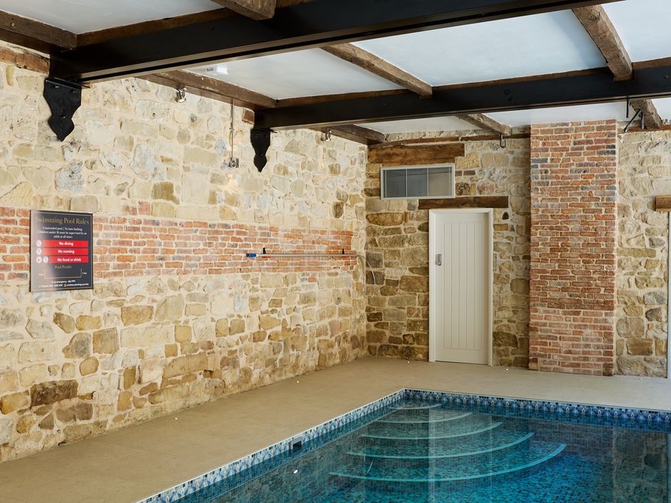 An indoor pool area with a swimming pool at The Card House in Hopton