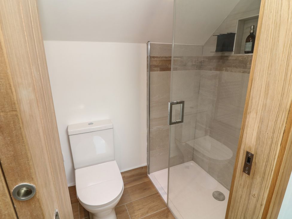A bathroom with a shower and toilet at Buzzard Barn in Woodhall Spa