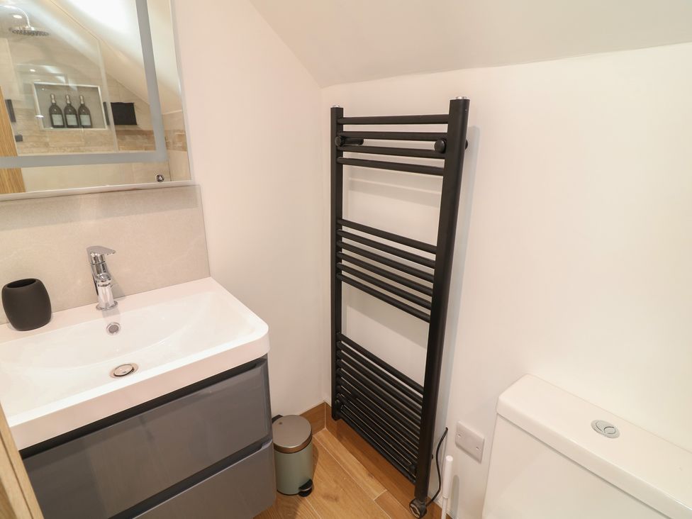 A bathroom with a sink and toilet at Buzzard Barn in Woodhall Spa