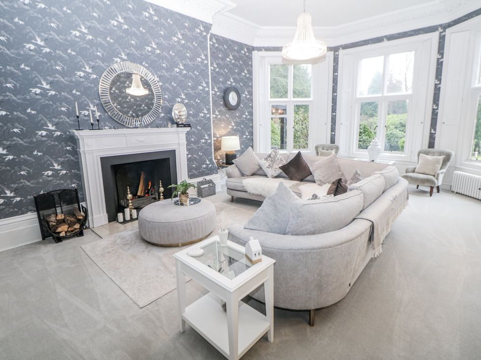 A living room with a sofa and fireplace at Hallfield Hall Shirland near Higham