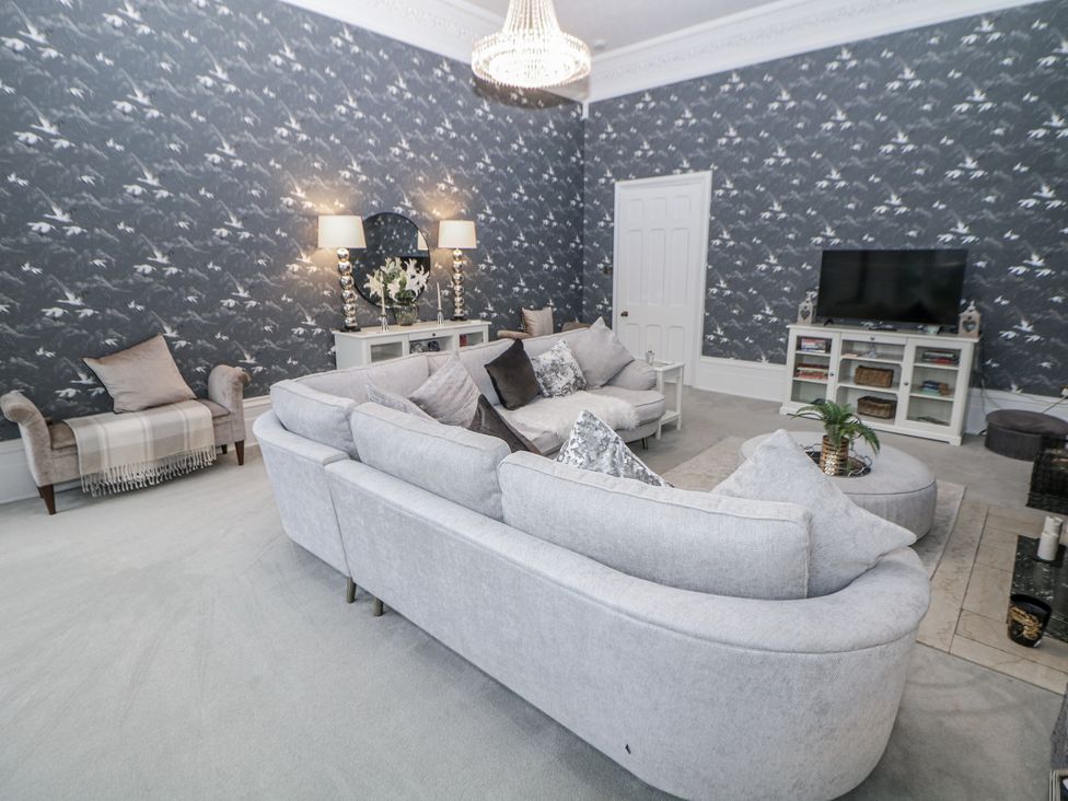 A living room with a sofa and television at Hallfield Hall in Shirland near Higham