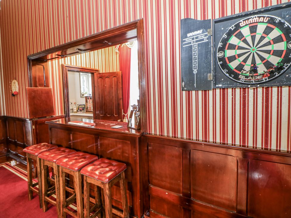 A snug with a dartboard and bar area at Hallfield Hall Shirland near Higham