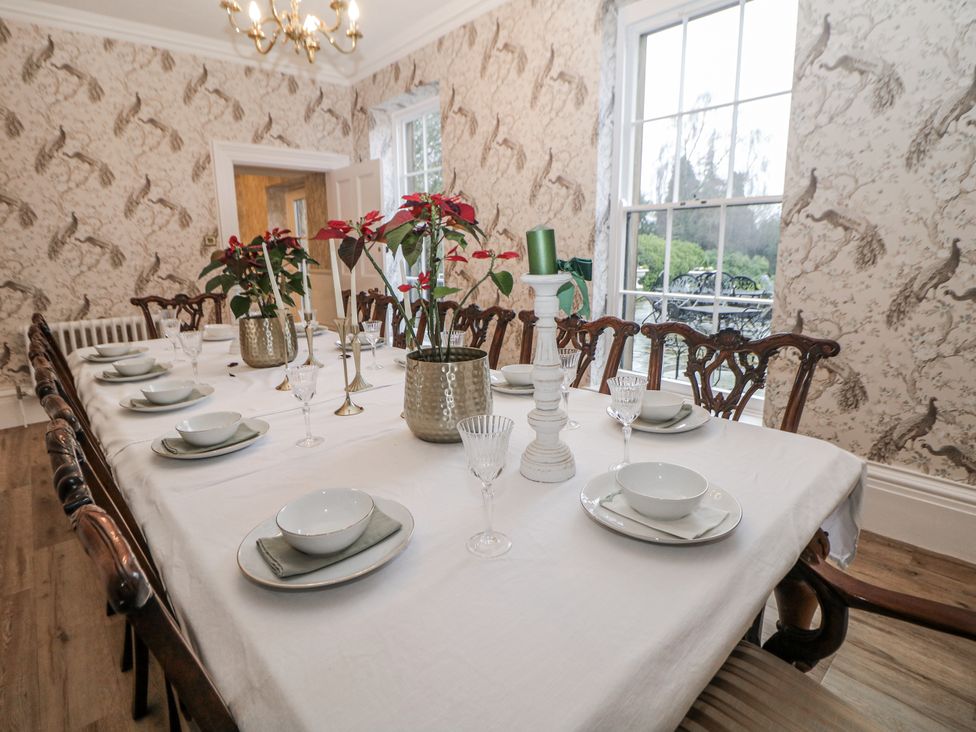 A dining room with a large table set for a meal at Hallfield Hall Shirland near Higham