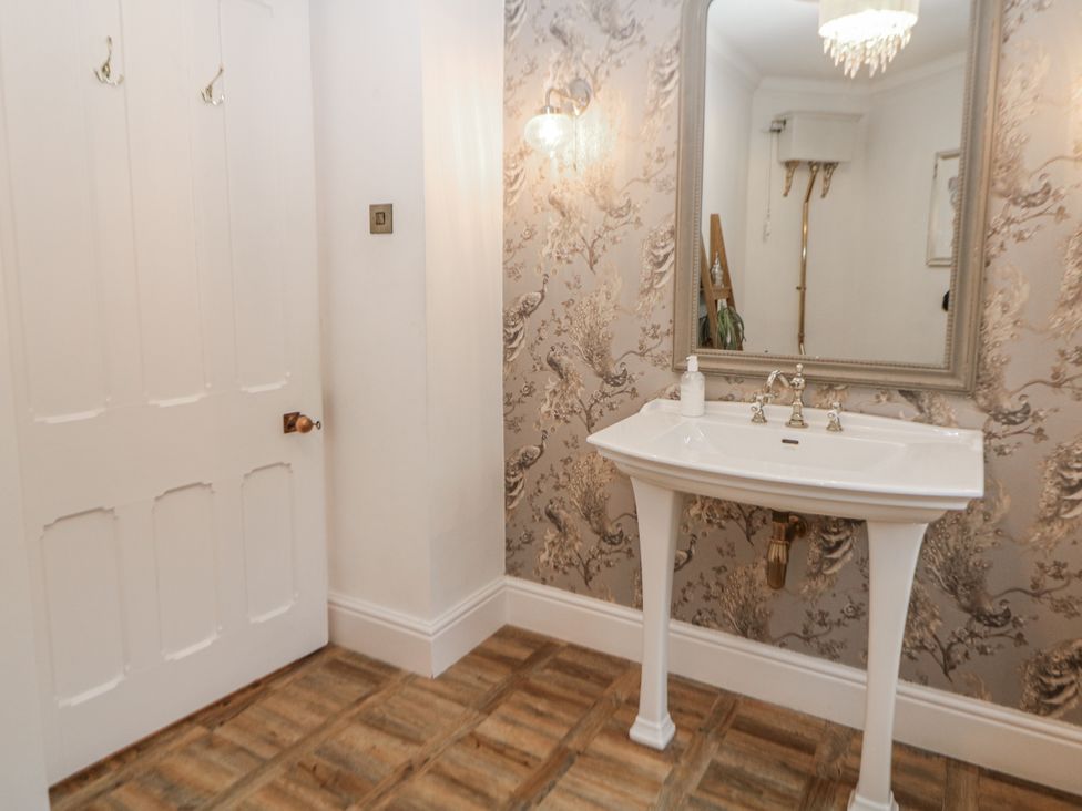 A bathroom with a sink and a mirror at Hallfield Hall Shirland near Higham