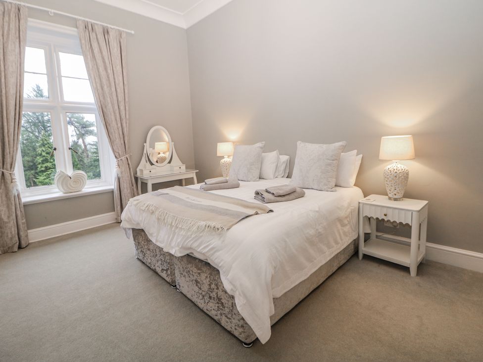 A bedroom with a bed and bedside table at Hallfield Hall Shirland near Higham