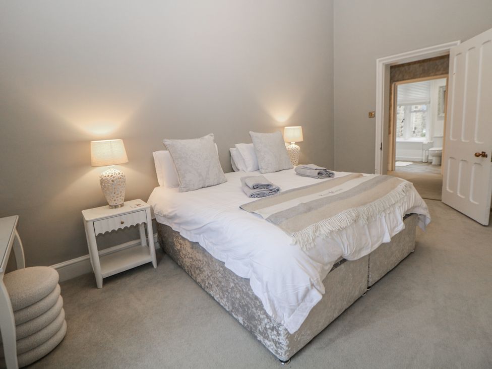 A bedroom with a bed and bedside table at Hallfield Hall in Shirland near Higham