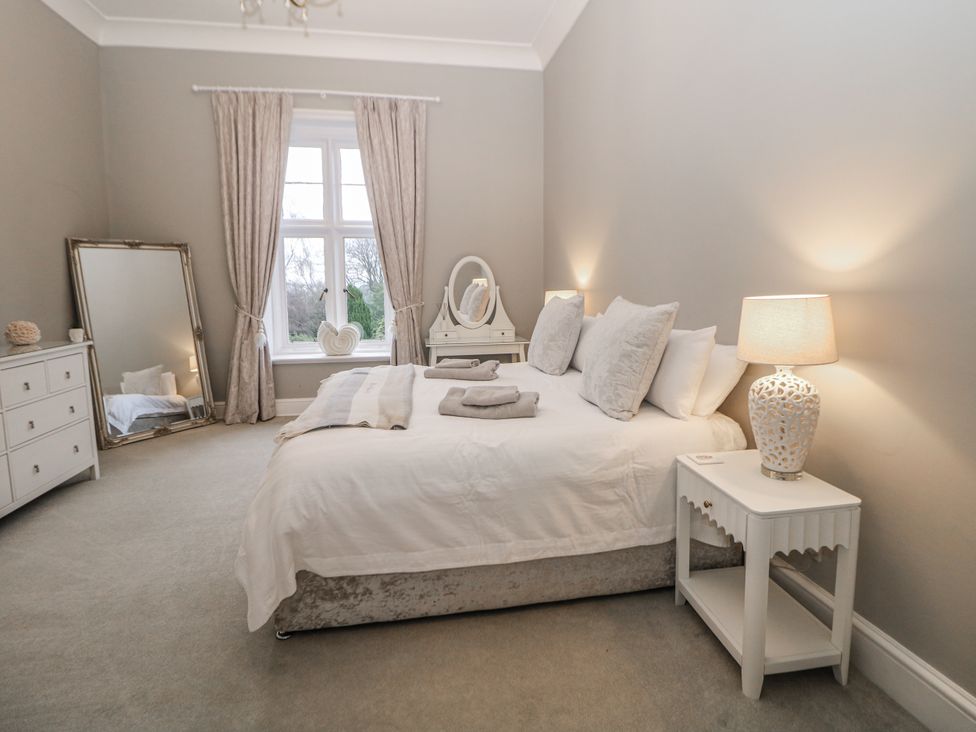 A bedroom with a bed and nightstand at Hallfield Hall Shirland near Higham