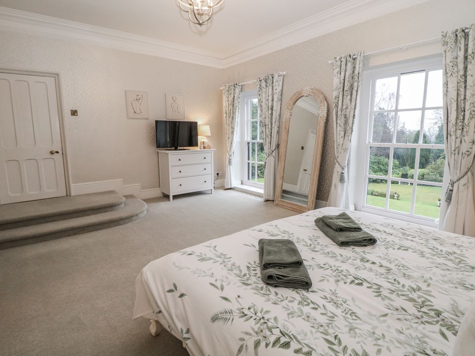 A bedroom with a bed and television at Hallfield Hall, Shirland near Higham