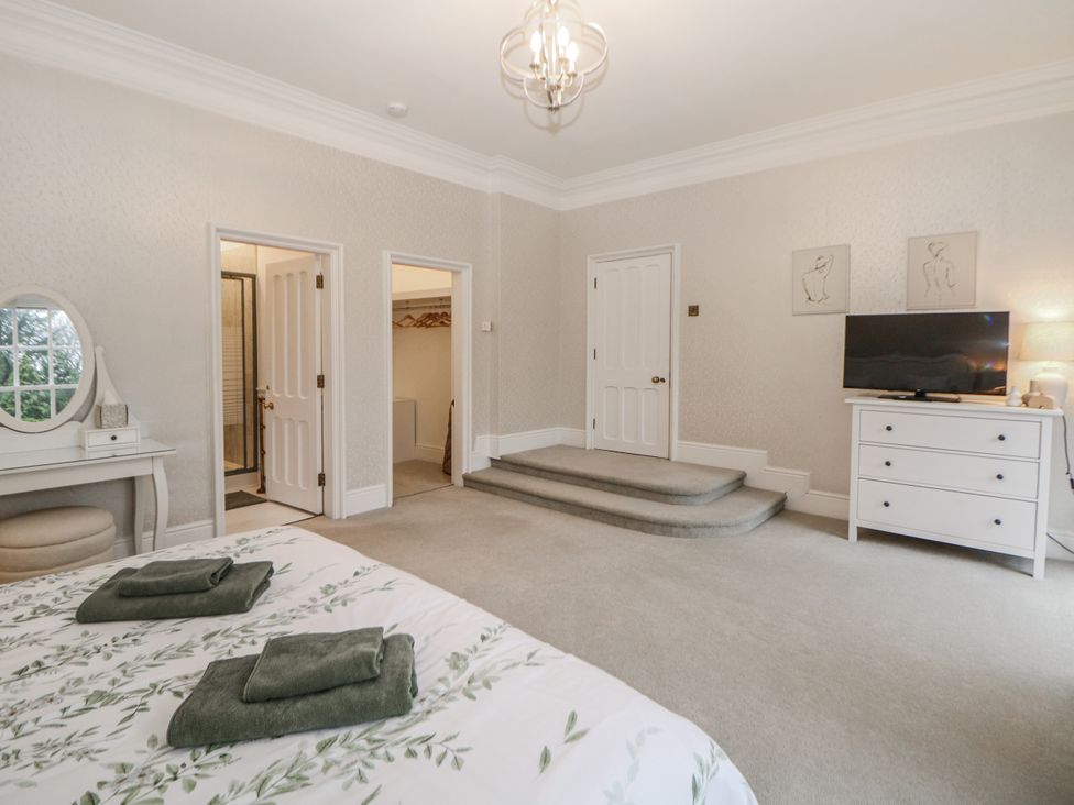 A bedroom with a bed and dresser at Hallfield Hall Shirland near Higham