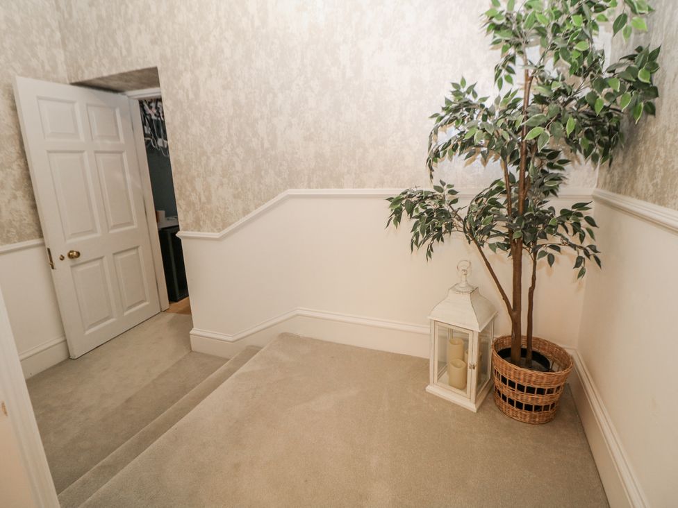 A hallway with a plant and lantern at Hallfield Hall Shirland near Higham