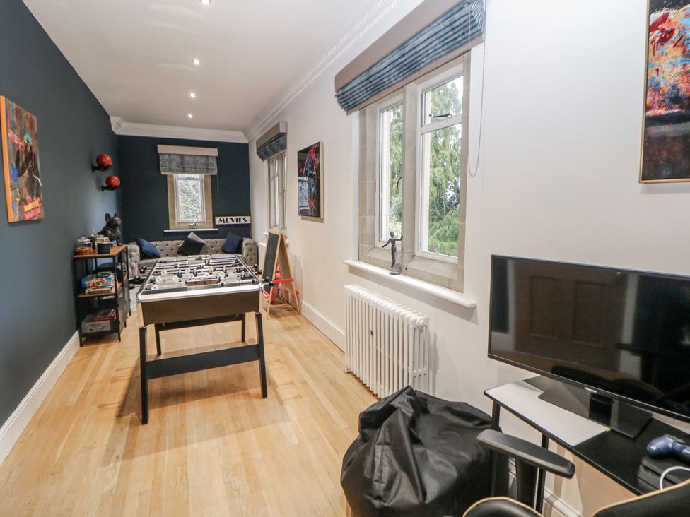 A game room with a foosball table and a sofa at Hallfield Hall Shirland near Higham